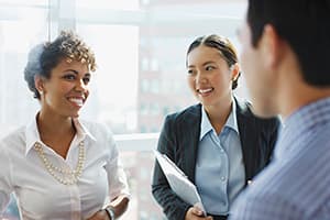 Three business people talking in office