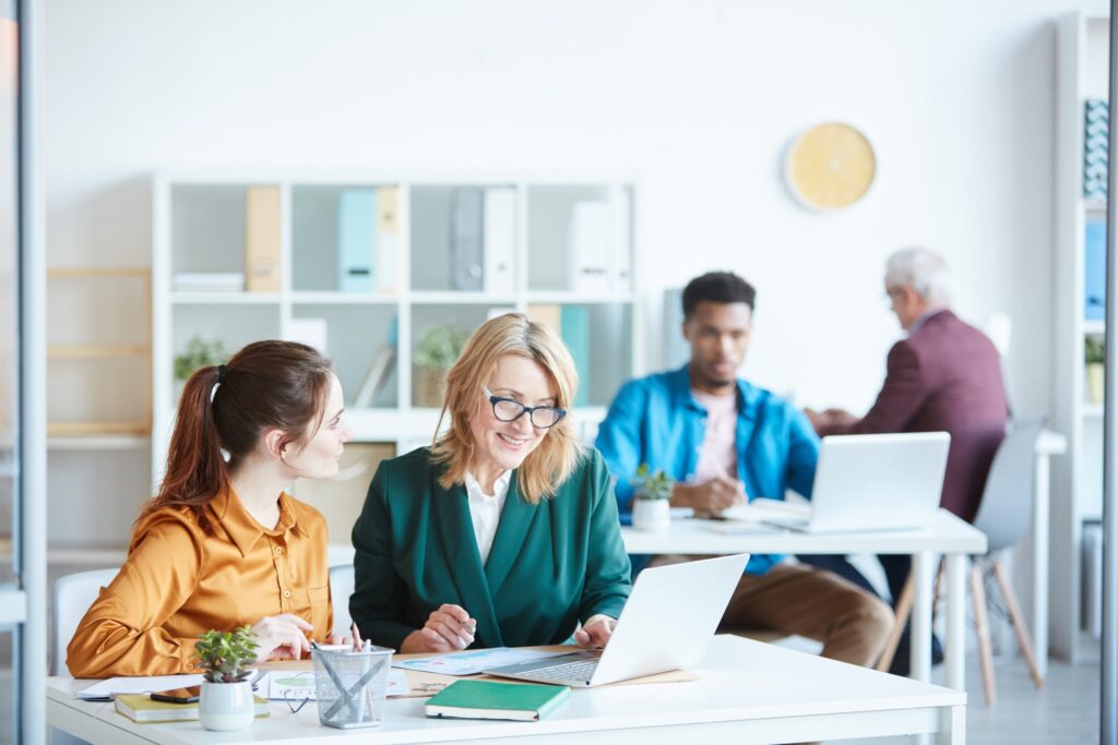 A group of business professionals collaborating in an office setting.
