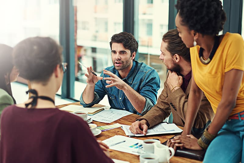 Group of young people holding a meeting in an office